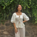 Cotton blouse with subtle chikankari embroidery, puff sleeves, and bow-tie neckline. Handcrafted in small batches by artisans in India for effortless slow fashion.
