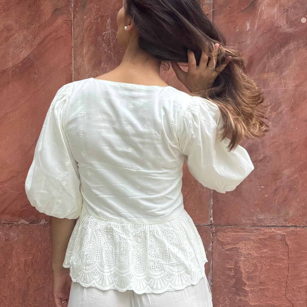Cotton blouse with subtle chikankari embroidery, puff sleeves, and bow-tie neckline. Handcrafted in small batches by artisans in India for effortless slow fashion.